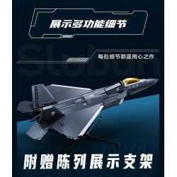 Mô hình F-22A-S Sluban M38-B1613 đặt trên giá đỡ, nhìn từ trên xuống, nổi bật thân xám đậm và cánh tam giác loe rộng